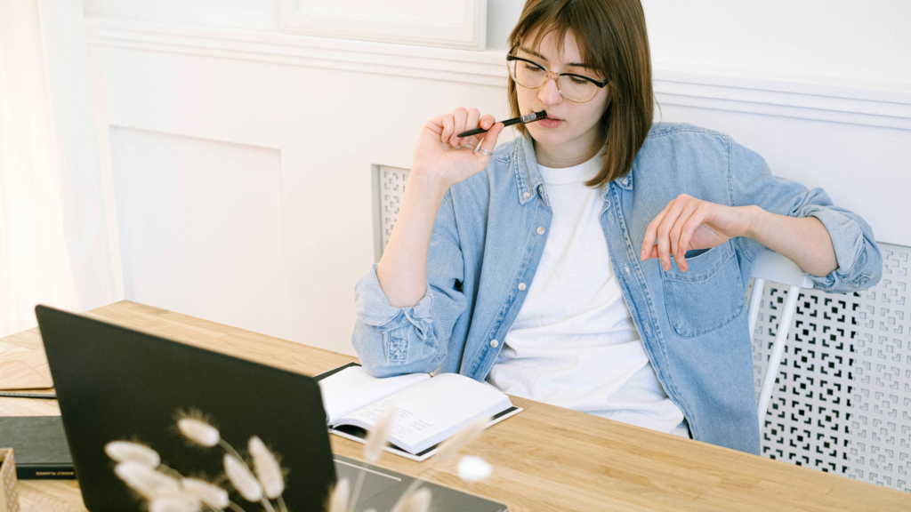 woman at laptop thinking